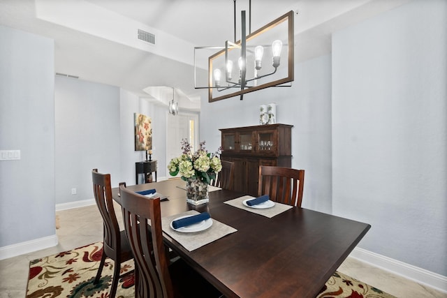 dining area featuring baseboards, visible vents, a chandelier, and light tile patterned flooring