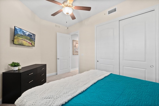 bedroom featuring light colored carpet, a closet, visible vents, and baseboards