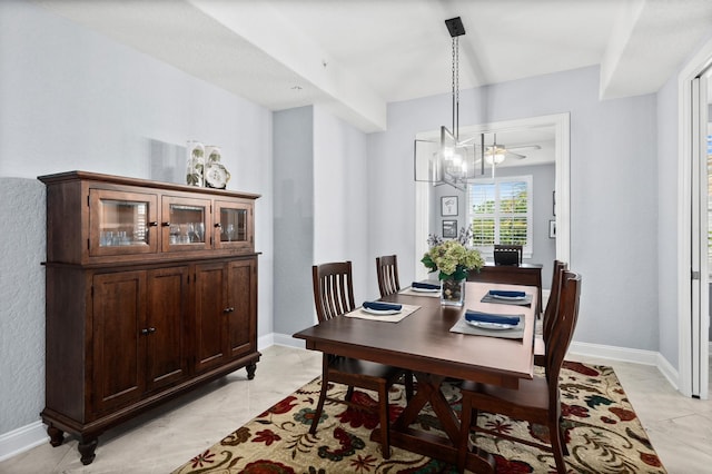 dining room featuring baseboards and a chandelier