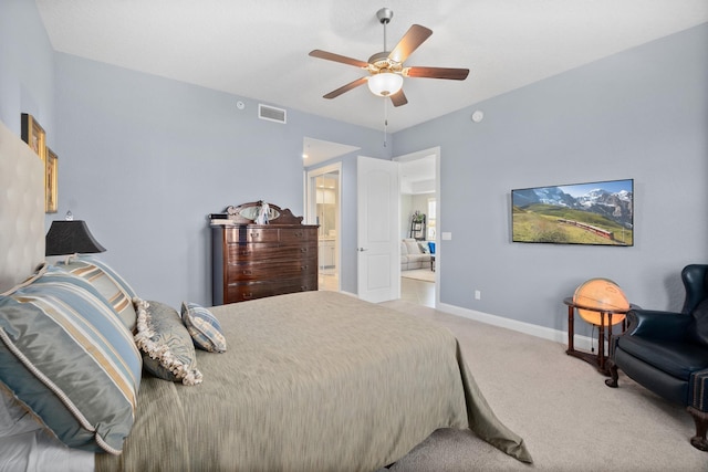 bedroom featuring carpet, visible vents, a ceiling fan, ensuite bath, and baseboards