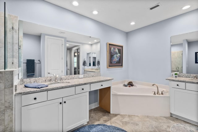 full bath featuring recessed lighting, two vanities, a stall shower, a sink, and a bath