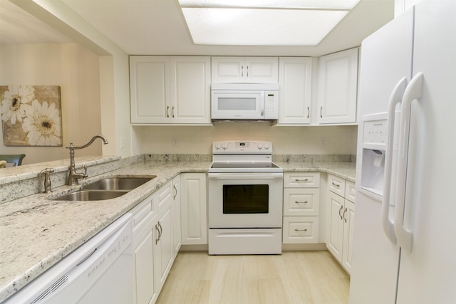 890 A1A Beach Blvd Unit 74, Saint Augustine Beach, FL 32080 - kitchen with white appliances, white cabinets, and light stone counters