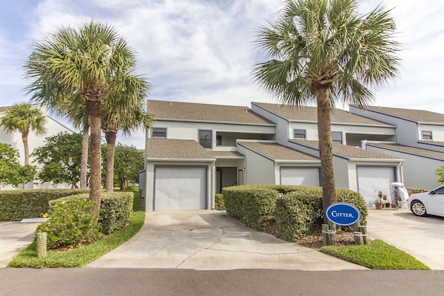 890 A1A Beach Blvd Unit 74, Saint Augustine Beach, FL 32080 - view of front of home featuring stucco siding, concrete driveway, and a shingled roof