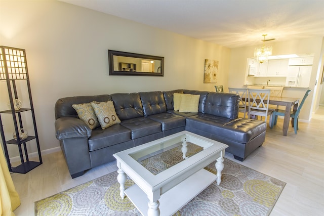 890 A1A Beach Blvd Unit 74, Saint Augustine Beach, FL 32080 - living room featuring baseboards and a chandelier