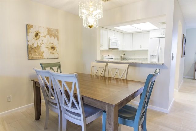 890 A1A Beach Blvd Unit 74, Saint Augustine Beach, FL 32080 - dining space with a chandelier and baseboards