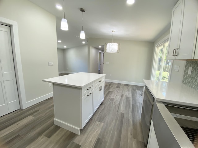 kitchen with white cabinetry, hanging light fixtures, and stainless steel dishwasher