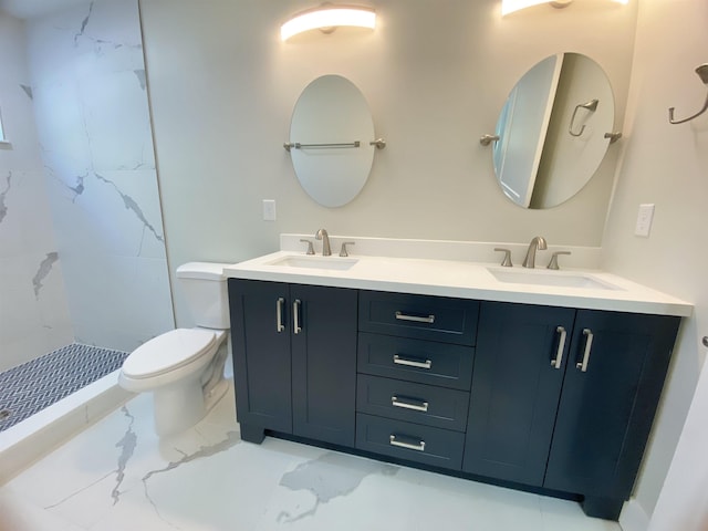 bathroom featuring a tile shower, vanity, and toilet