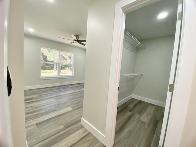 interior space with wood-type flooring and ceiling fan