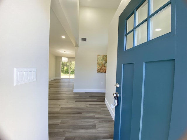 foyer featuring hardwood / wood-style flooring and a notable chandelier