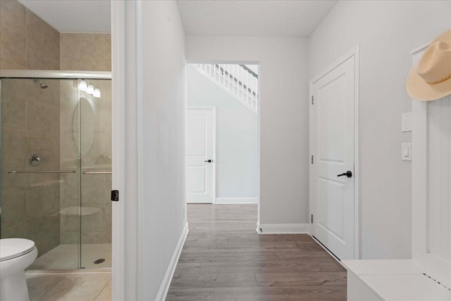295 Ferndale Way, Saint Augustine, FL 32092 - bathroom featuring a shower stall, wood finished floors, toilet, and baseboards