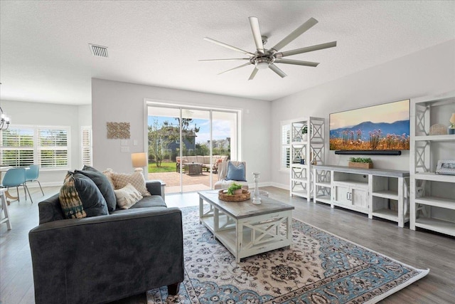 295 Ferndale Way, Saint Augustine, FL 32092 - living room with a ceiling fan, wood finished floors, a textured ceiling, a chandelier, and baseboards