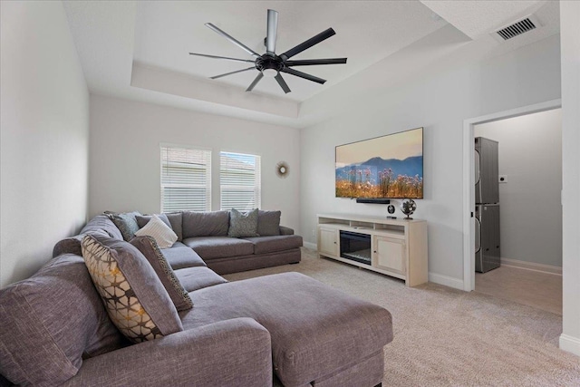 295 Ferndale Way, Saint Augustine, FL 32092 - living area with a ceiling fan, light carpet, a tray ceiling, and baseboards