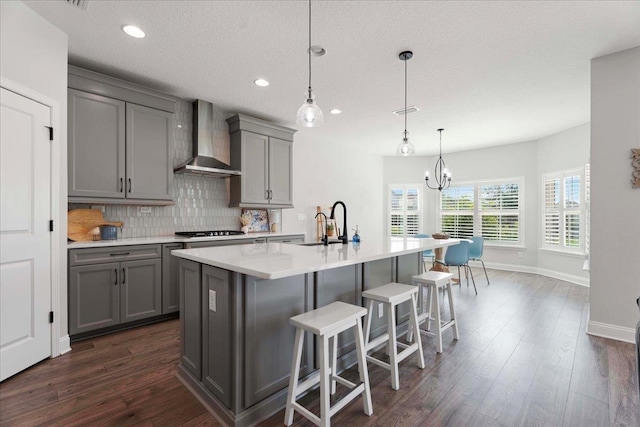 295 Ferndale Way, Saint Augustine, FL 32092 - kitchen featuring gray cabinets, wall chimney range hood, backsplash, gas cooktop, and dark wood-style flooring