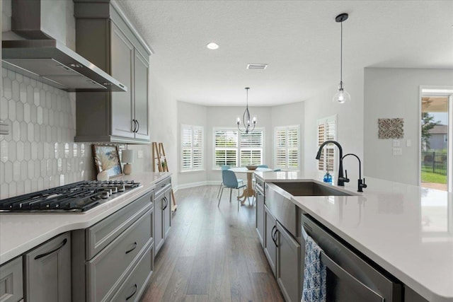 295 Ferndale Way, Saint Augustine, FL 32092 - kitchen featuring wall chimney exhaust hood, a sink, appliances with stainless steel finishes, gray cabinetry, and recessed lighting