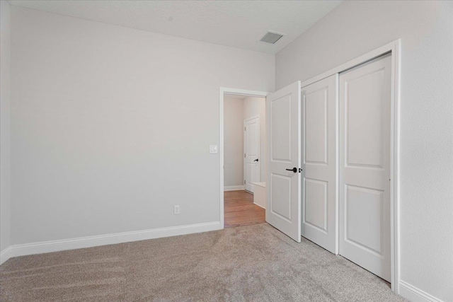 295 Ferndale Way, Saint Augustine, FL 32092 - unfurnished bedroom featuring light colored carpet, baseboards, and a closet