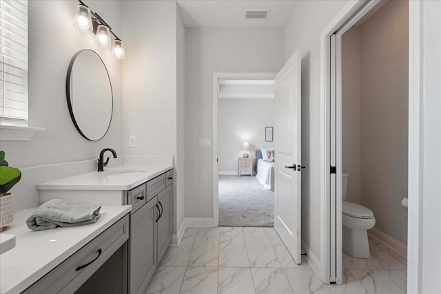 295 Ferndale Way, Saint Augustine, FL 32092 - ensuite bathroom with marble finish flooring, vanity, toilet, and baseboards