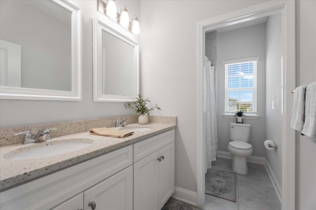 295 Ferndale Way, Saint Augustine, FL 32092 - bathroom with double vanity, baseboards, toilet, and tile patterned floors