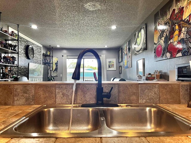 kitchen with sink and a textured ceiling