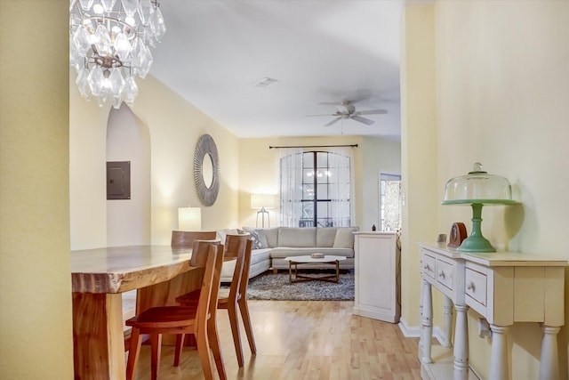 dining area featuring ceiling fan, electric panel, and light hardwood / wood-style flooring