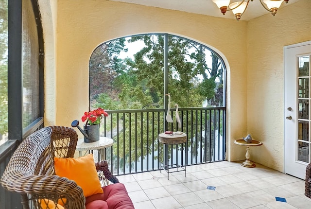 sunroom featuring a chandelier