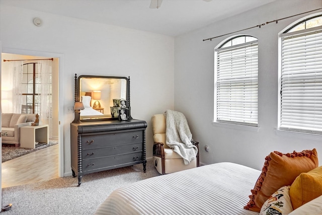 carpeted bedroom featuring multiple windows