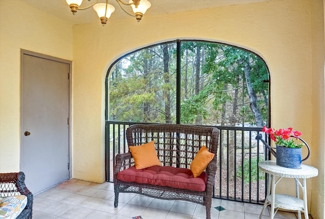 sunroom / solarium with a chandelier