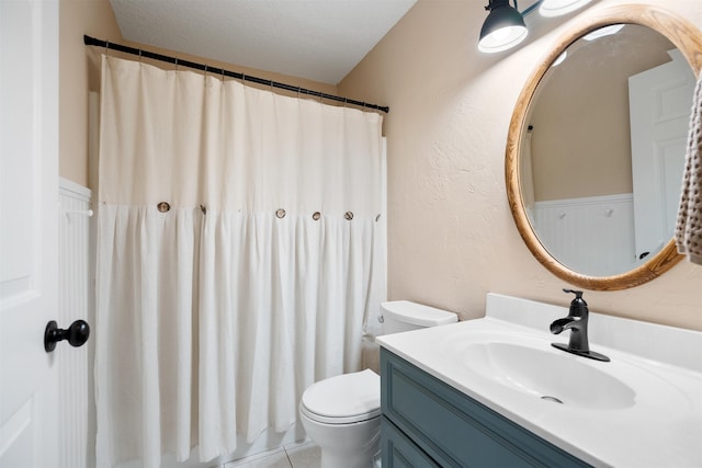 bathroom featuring tile patterned flooring, vanity, toilet, and a textured ceiling