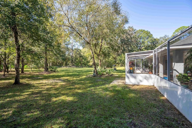 view of yard featuring glass enclosure