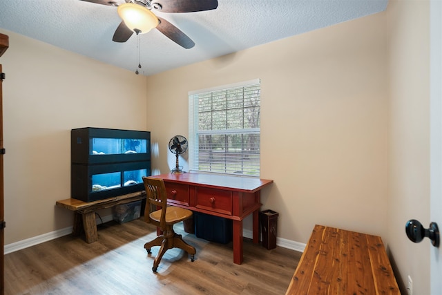 home office featuring ceiling fan, hardwood / wood-style floors, and a textured ceiling