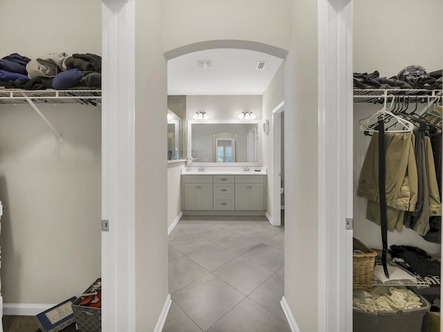 55 Concave Ln, Saint Augustine, FL 32095 - bathroom featuring vanity, a walk in closet, and baseboards