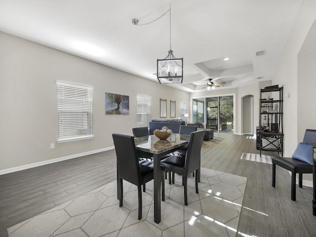 55 Concave Ln, Saint Augustine, FL 32095 - dining space with wood finished floors, a ceiling fan, arched walkways, a chandelier, and baseboards