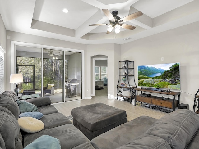 55 Concave Ln, Saint Augustine, FL 32095 - living room featuring ceiling fan, coffered ceiling, arched walkways, light wood-type flooring, and plenty of natural light