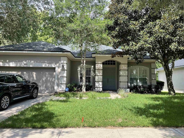 ranch-style home with a garage and a front lawn