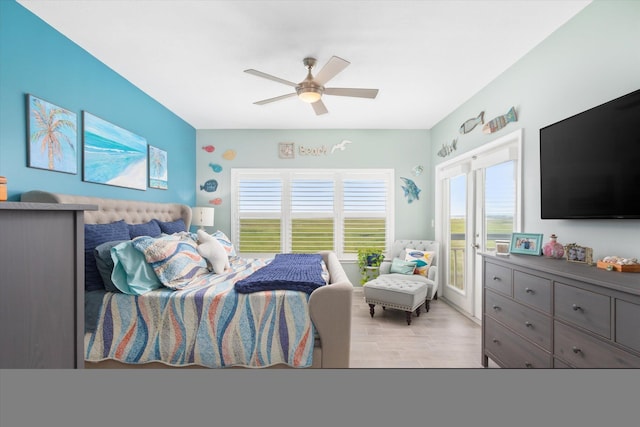 bedroom with ceiling fan, light wood-type flooring, and multiple windows