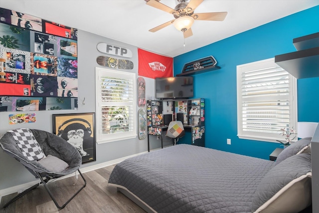 bedroom with hardwood / wood-style floors and ceiling fan