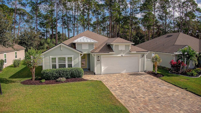 view of front facade featuring a front yard, decorative driveway, a garage, and roof with shingles