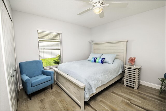 bedroom with ceiling fan, a closet, and hardwood / wood-style flooring