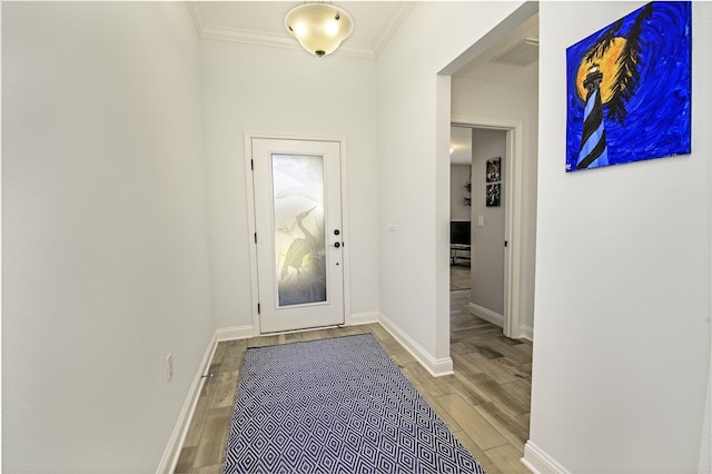 doorway with ornamental molding and hardwood / wood-style flooring