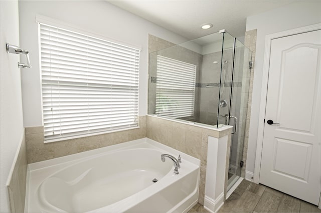 bathroom with shower with separate bathtub, hardwood / wood-style flooring, and plenty of natural light