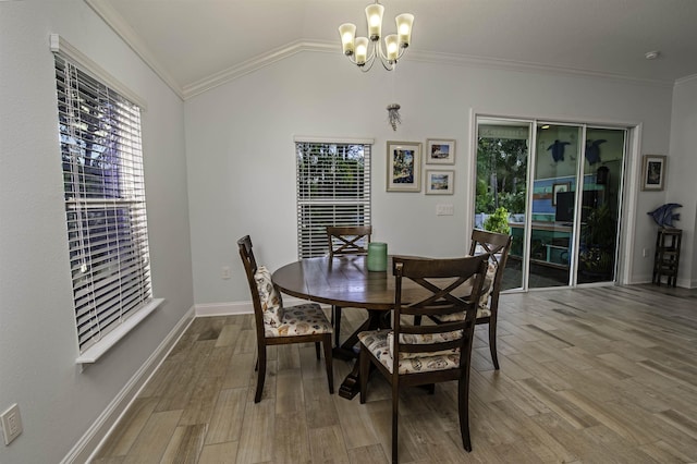 dining space with an inviting chandelier, wood-type flooring, crown molding, and vaulted ceiling