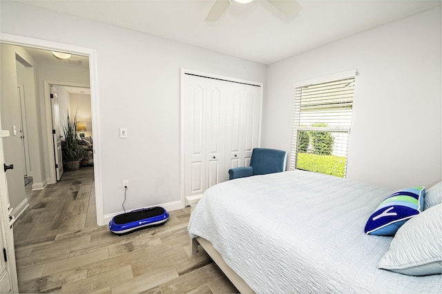 bedroom with ceiling fan, a closet, and light wood-type flooring