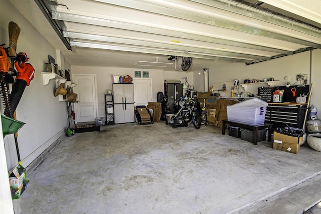 garage with white fridge and a garage door opener