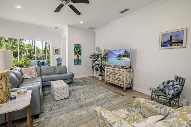 living room with crown molding, ceiling fan, and wood-type flooring