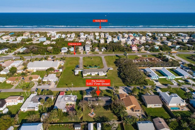 bird's eye view featuring a water view, a residential view, and a view of the beach