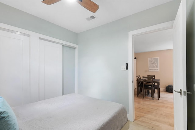 bedroom with light wood-style floors and ceiling fan