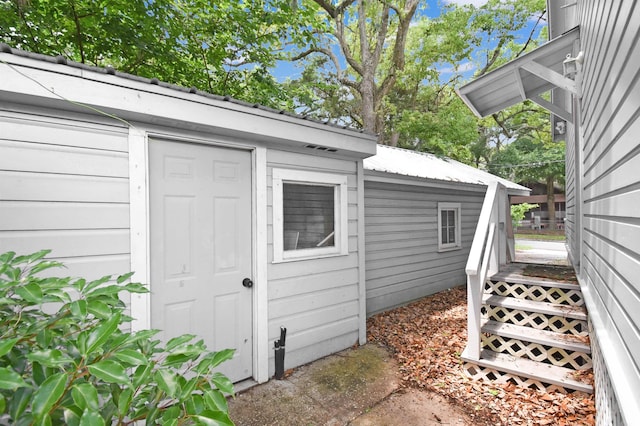 entrance to property featuring metal roof