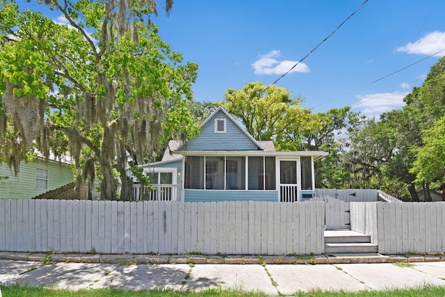 bungalow with a sunroom and a gate