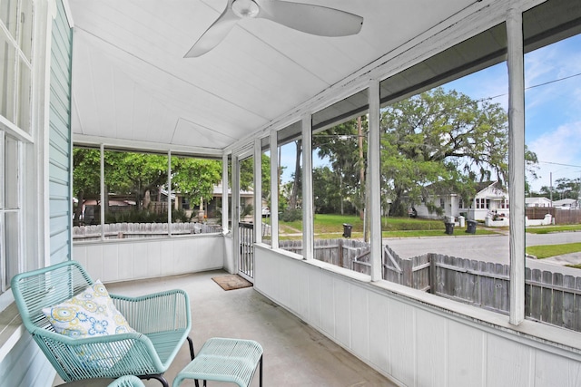 sunroom / solarium with ceiling fan and vaulted ceiling