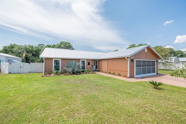 single story home featuring a garage and a front yard