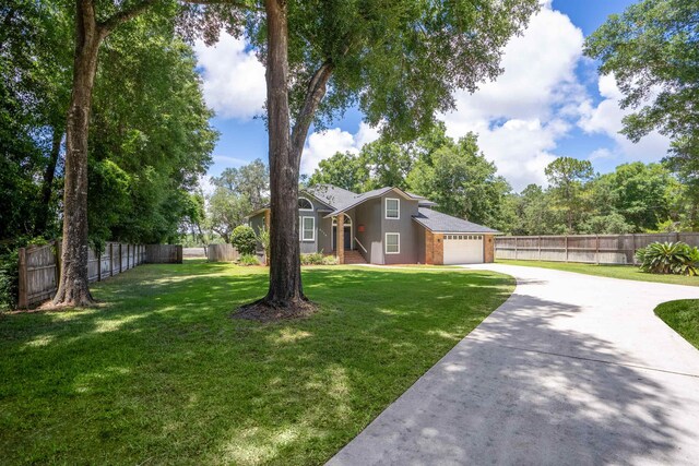 exterior space featuring a garage and a front lawn